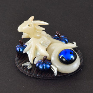 Tiny ghost wyvern with blue pumpkins