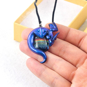 Blue wyvern necklace with dark rainbow dichroic glass focal