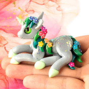 Gray unicorn with rainbow flowers
