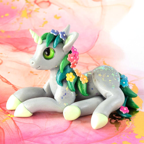 Gray unicorn with rainbow flowers