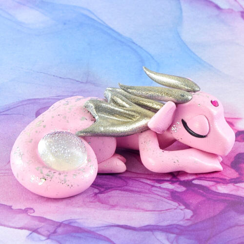 Sleeping pink and silver dragon